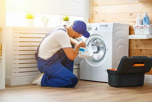 SB Repair technician servicing a washing machine